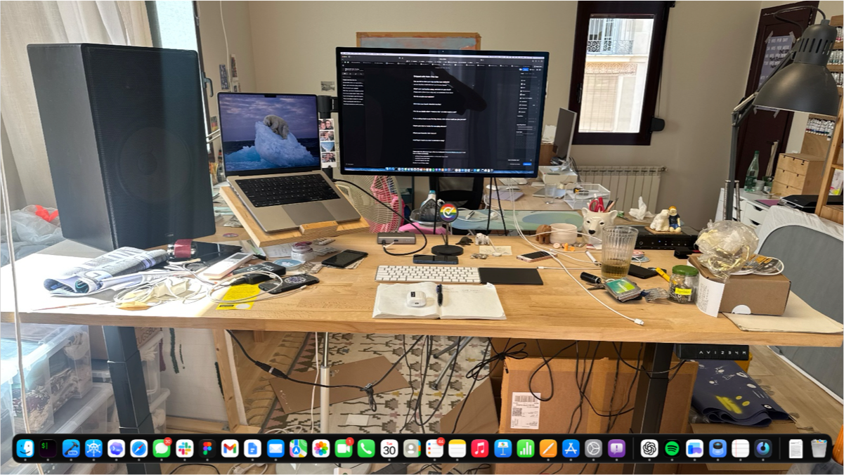 Frederik Riedel's workstation with a 14-inch MacBook Pro, Studio Display, and standing desk